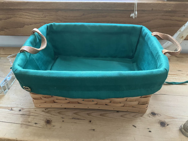 Basket with leather handles and green liner